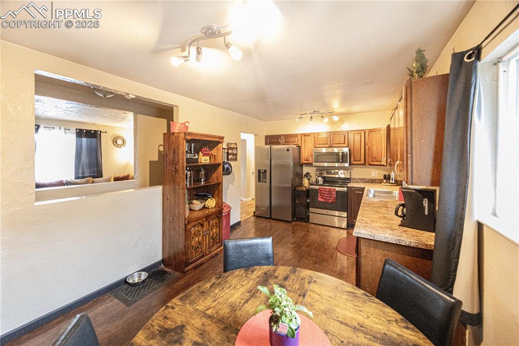 Image 7 of 22: Wall opening gives view of basement and living room! 