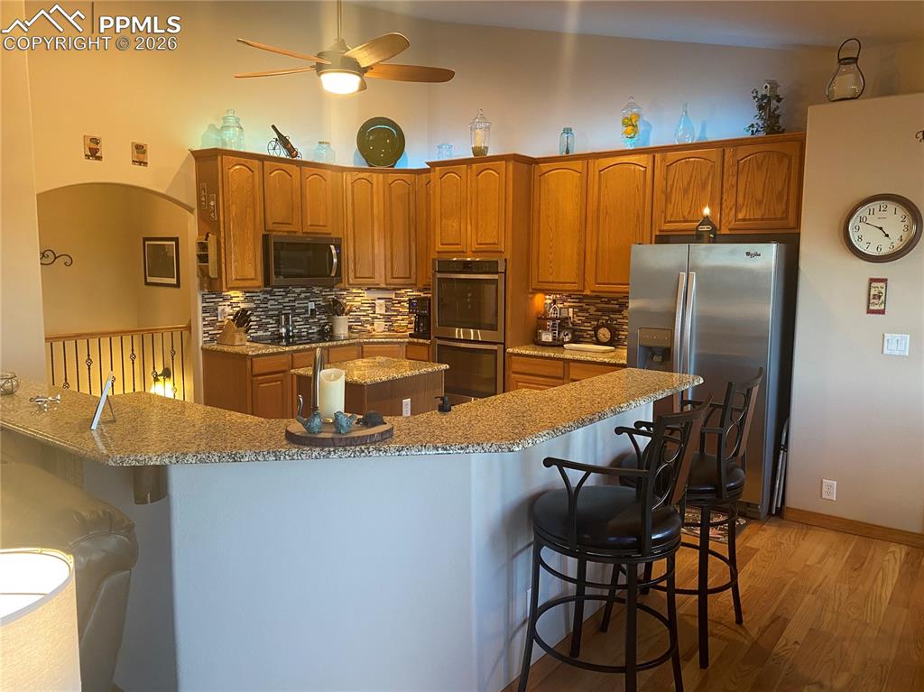 Image 13 of 47: Featuring granite countertops and stainless steel appliances