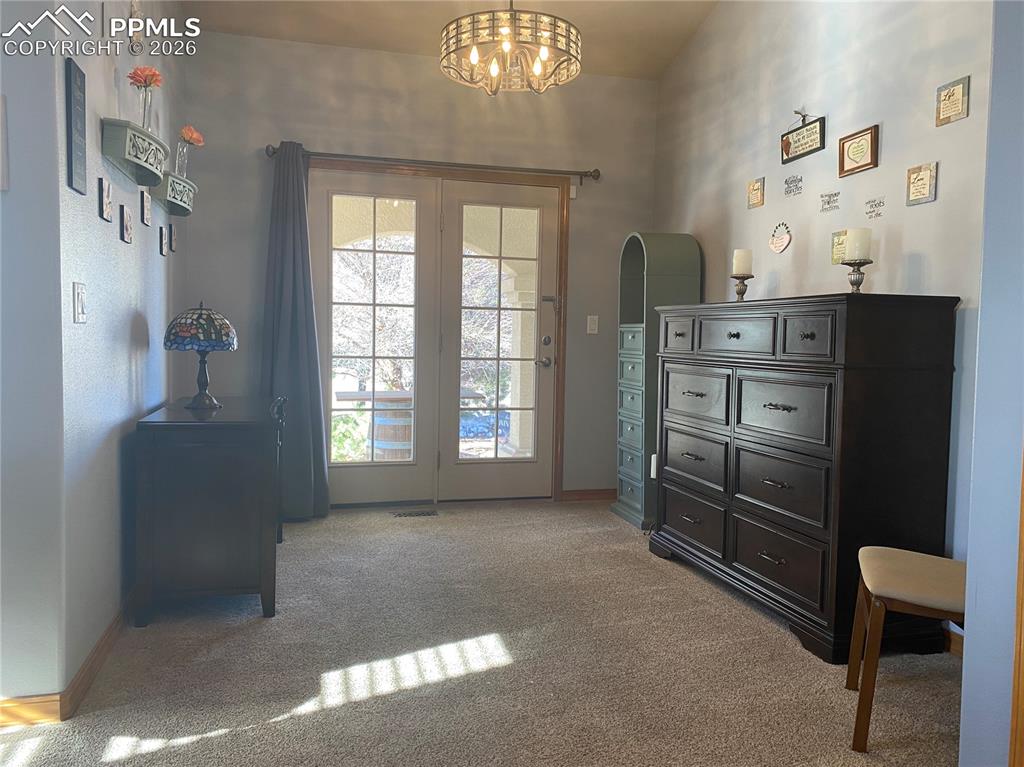 Image 18 of 47: And features a sitting room with front patio walk-out