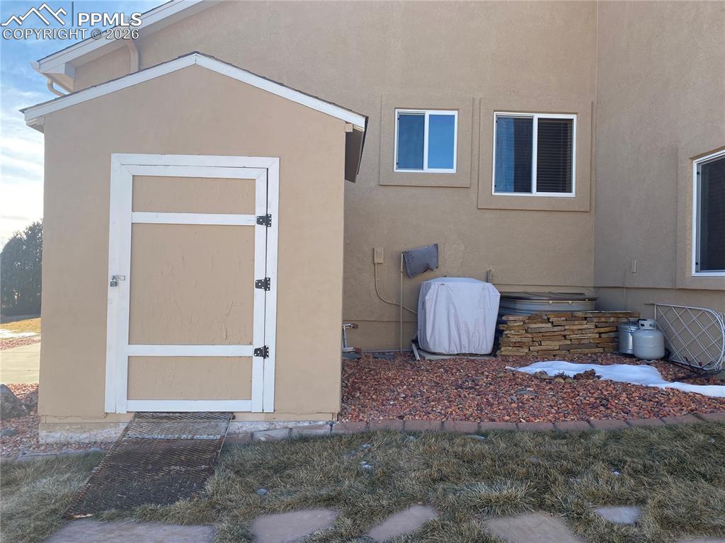 Image 42 of 47: A shed with matching stucco is great for outdoor storage