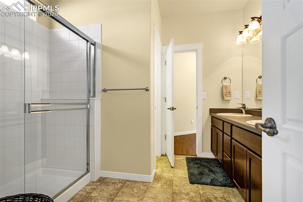 Image 10 of 42: Bathroom featuring vanity and an enclosed shower