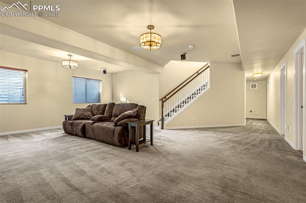 Image 18 of 42: Living room featuring carpet flooring