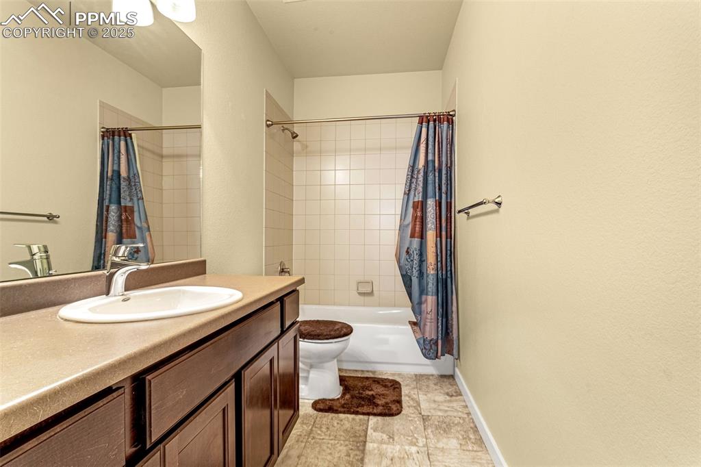 Image 19 of 42: Full bathroom featuring vanity, toilet, and shower / bath combo with shower