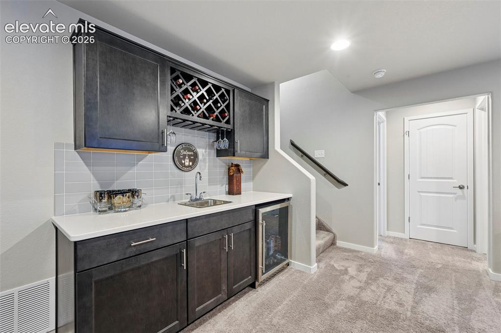 Image 32 of 50: Wet bar in basement