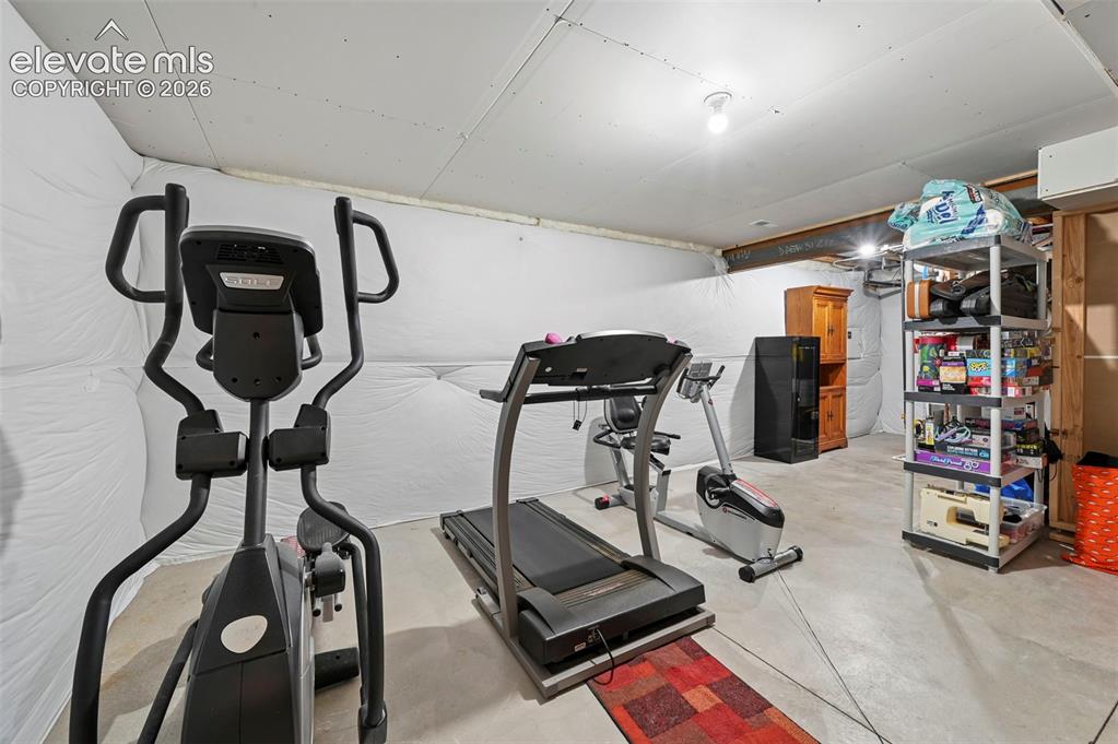Image 38 of 50: Large store room with plenty of space for a home gym.