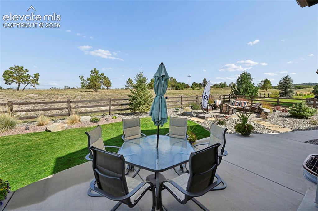 Image 42 of 50: Large concrete patio just outside sliding doors