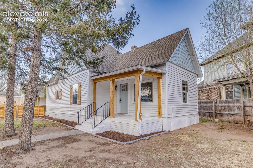 Image 4 of 27: Exterior featuring white siding, a covered porch with natural wood posts, a
