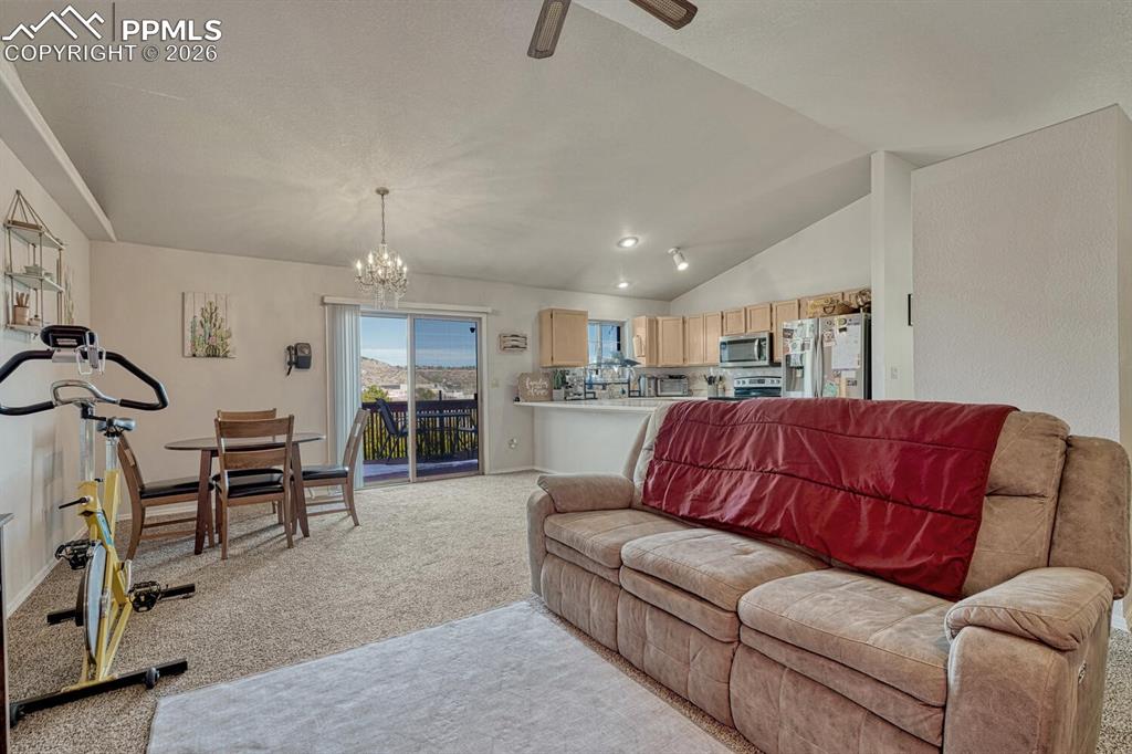 Image 10 of 40: Living room, dining room and walkout to deck