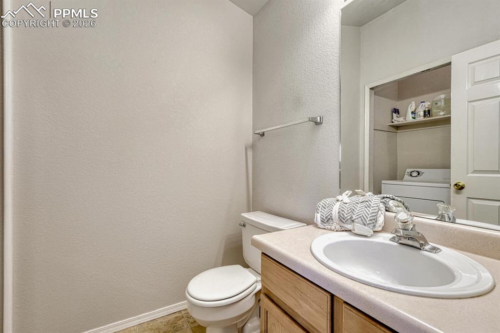 Image 16 of 40: Main level power room with attached laundry area