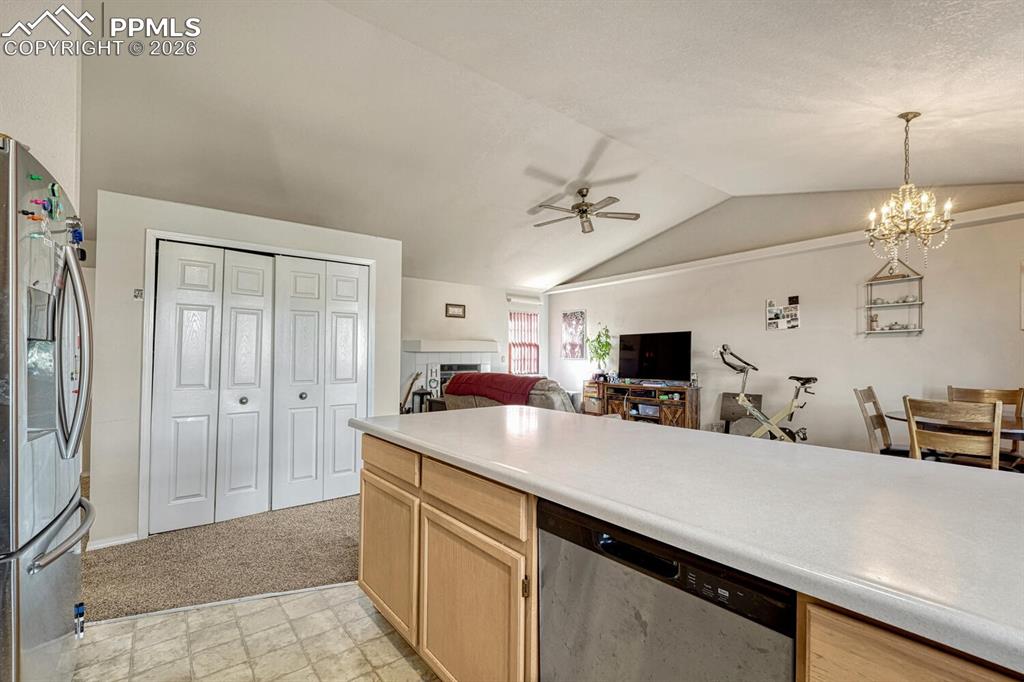 Image 9 of 40: Kitchen opens to living room and dining room, large pantry.