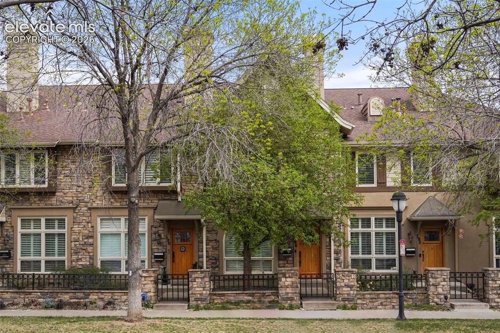 Caption: Stone veneer facade featuring multiple dormer windows and a gabled roofline