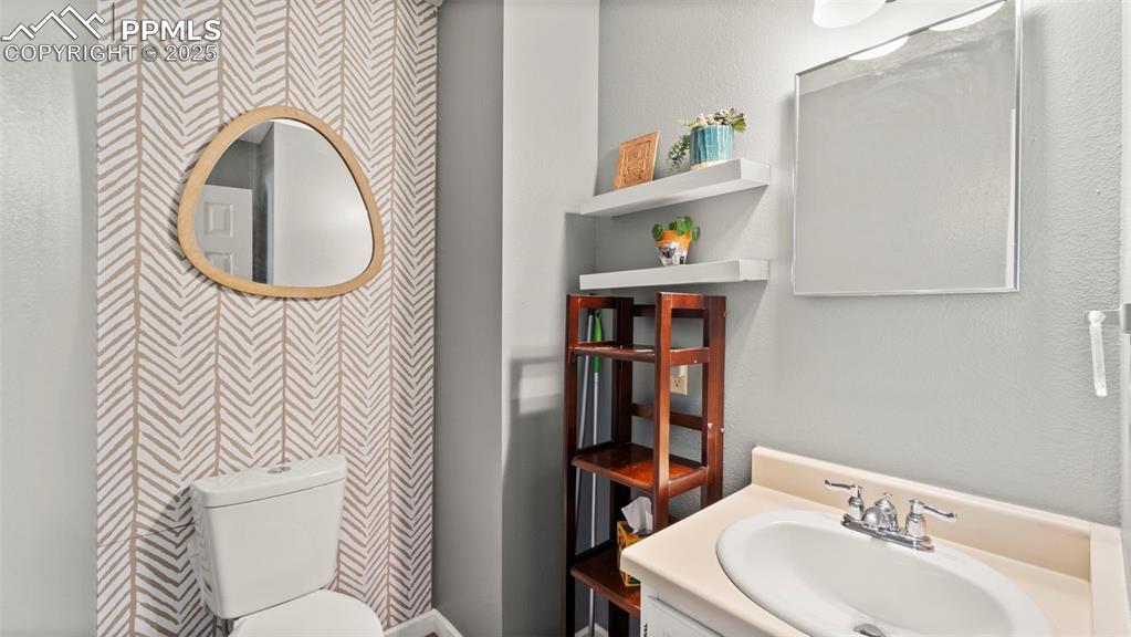 Image 13 of 38: Main level powder room.