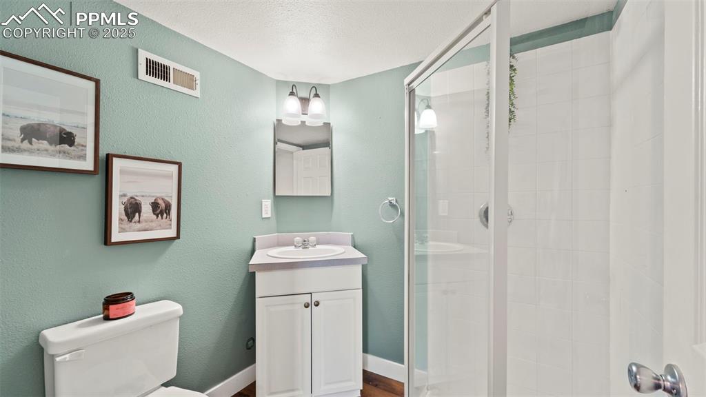 Image 24 of 38: Upgraded 3/4 bath with nely tiled shower!