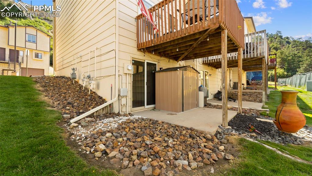 Image 26 of 38: Back patio with storage shed.