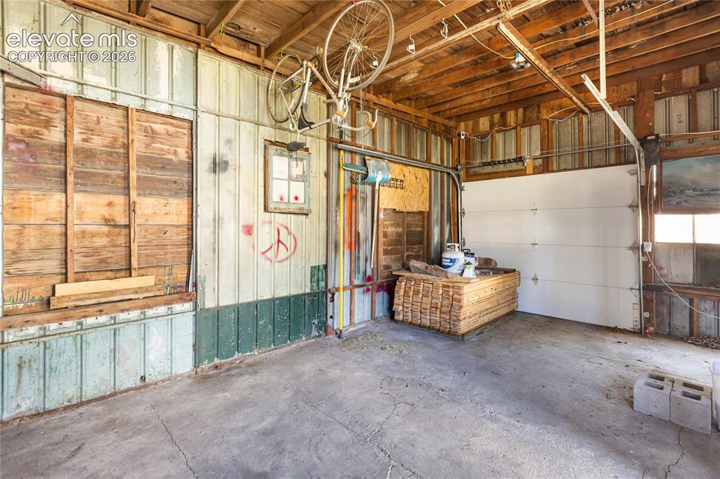Image 29 of 29: Huge garage with building materials for fence