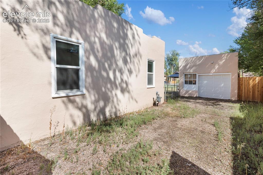 Image 7 of 29: Side of home to garage