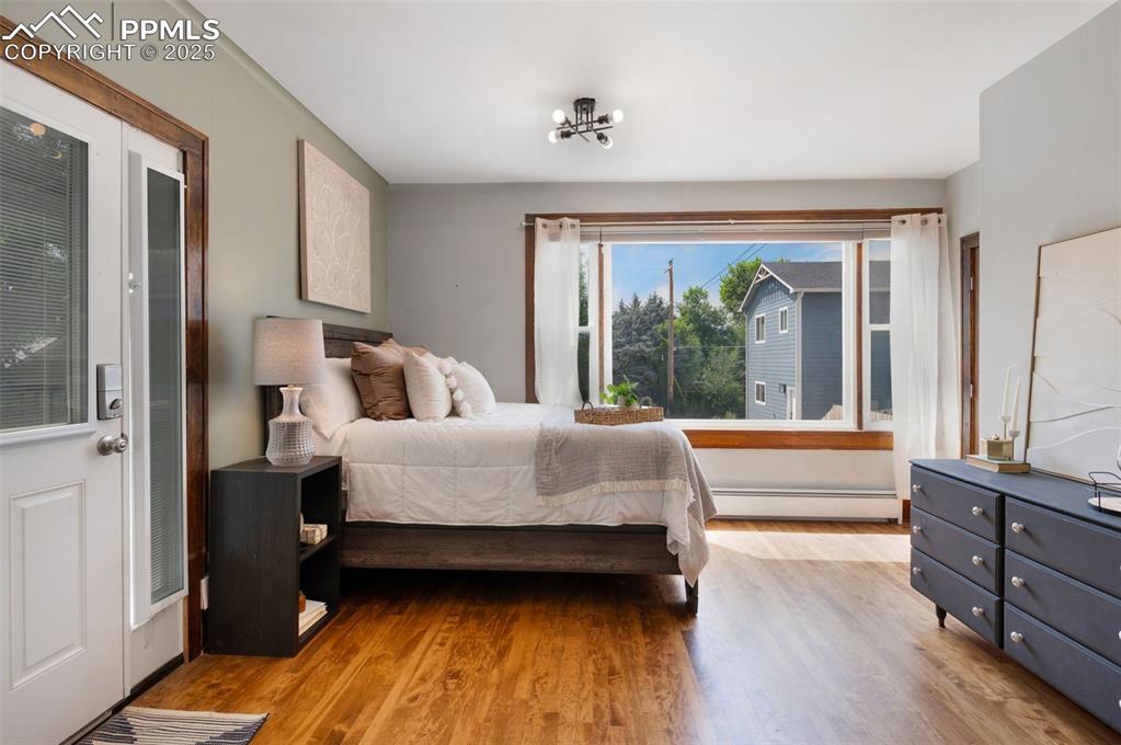 Image 14 of 31: Main level bedroom with access to deck