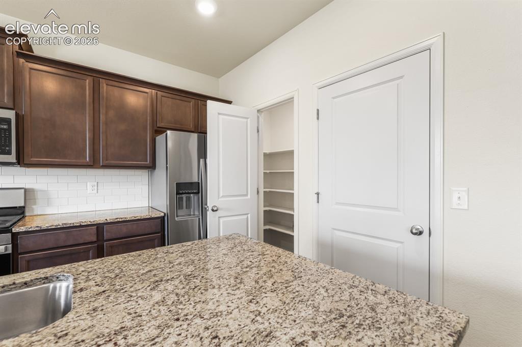 Image 16 of 42: Island Kitchen with breakfast bar.
