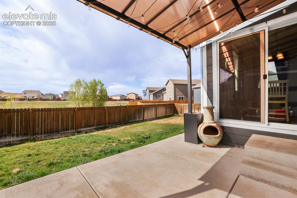 Image 23 of 42: Sliding door out to a covered patio from the Dining Area.