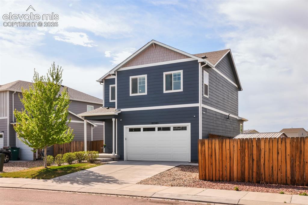 Image 3 of 42: The low-maintenance landscaping and charming covered front porch create inv