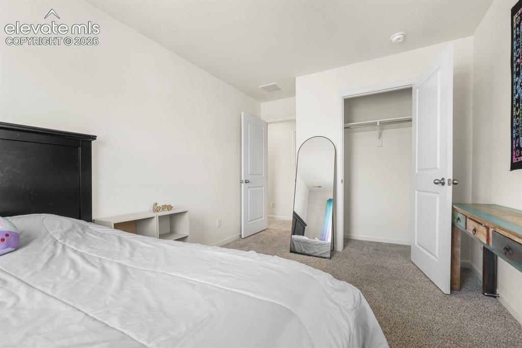 Image 38 of 42: Upper Level Laundry Room with washer and dryer that stays.