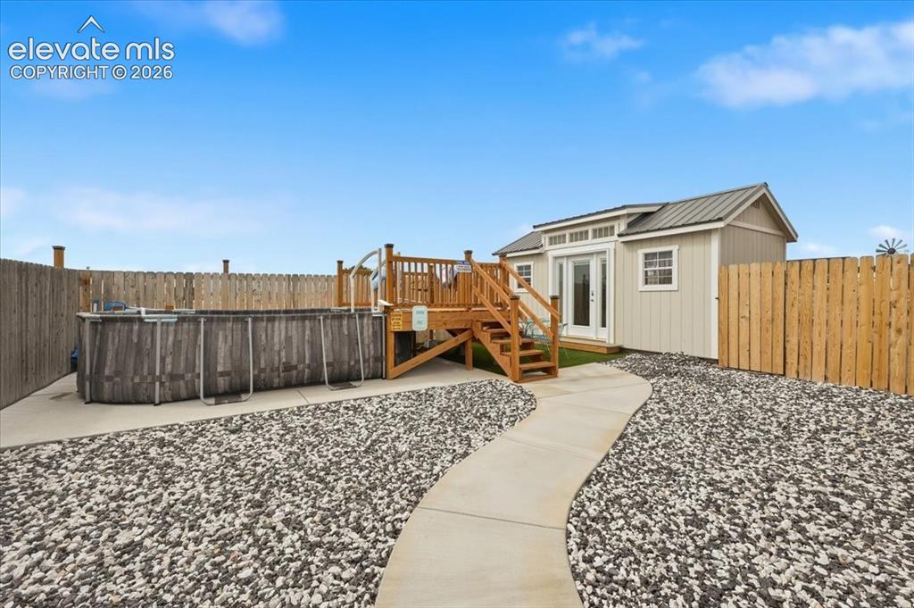 Image 45 of 50: Pool with built around deck, newly built shed