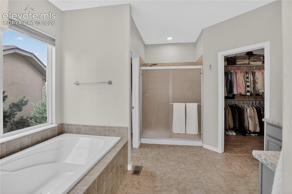 Image 10 of 27: 5-piece primary bath & walk-in closet