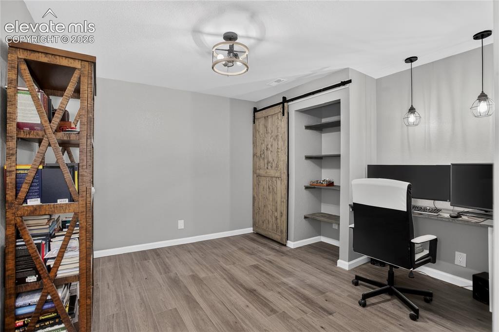 Image 21 of 27: Lower level bonus room - currently used as an office