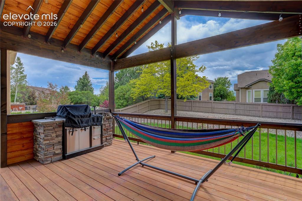 Image 25 of 27: Covered deck w/ built-in grill