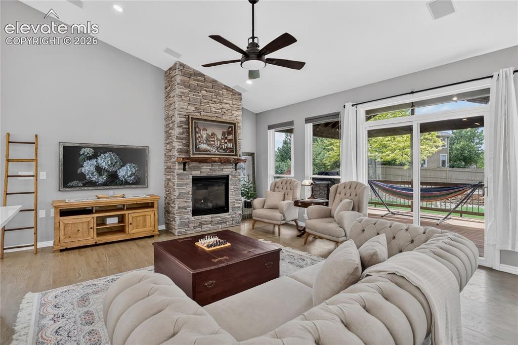 Image 4 of 27: Living room w/ stacked stone fireplace