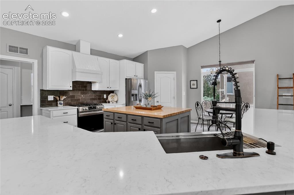 Image 6 of 27: Butcherblock & quartz counters for double islands