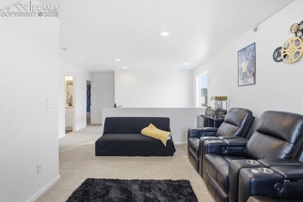 Image 14 of 36: Living room featuring light colored carpet and recessed lighting