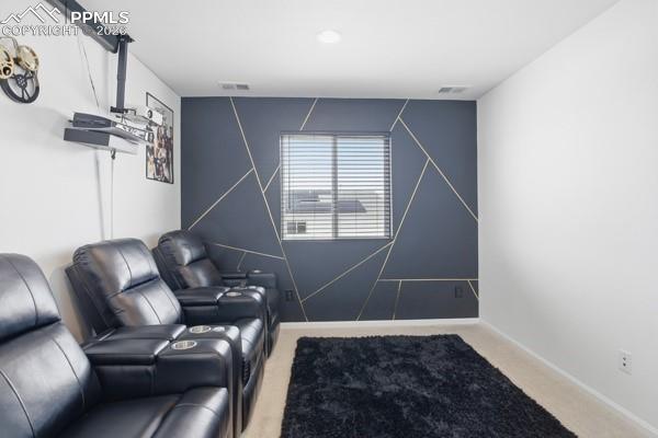 Image 15 of 36: Home theater room with carpet flooring and an accent wall