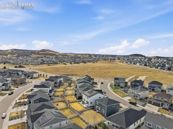 Image 18 of 36: Aerial perspective of suburban area featuring a mountainous background
