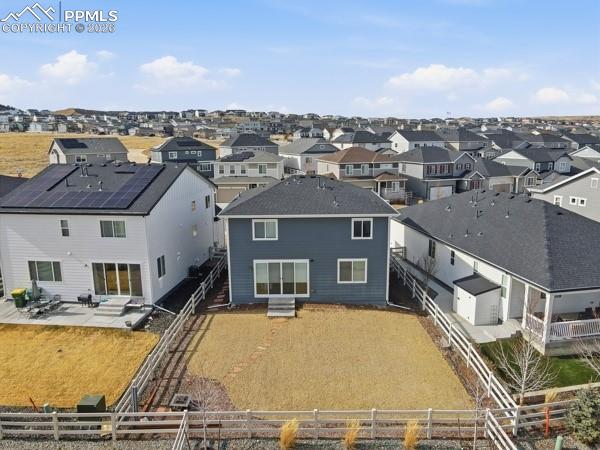 Image 19 of 36: Back of house with a patio, a residential view, and a fenced backyard
