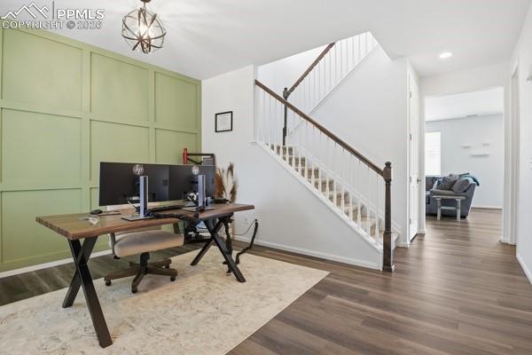 Image 3 of 36: Office featuring a decorative wall and dark wood-type flooring