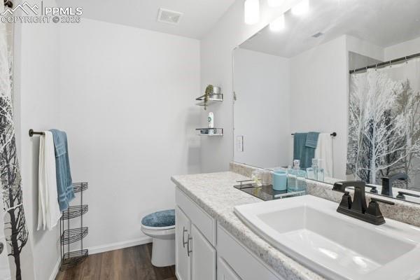 Image 30 of 36: Bathroom with a shower with curtain, vanity, and dark wood-type flooring