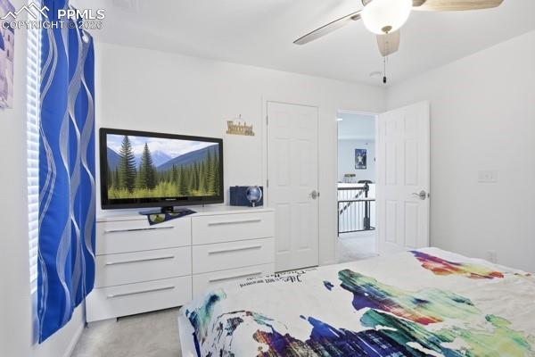 Image 32 of 36: Bedroom featuring light colored carpet and ceiling fan