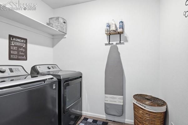 Image 33 of 36: Laundry area featuring separate washer and dryer and baseboards