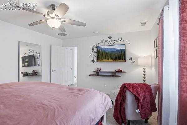 Image 34 of 36: Carpeted bedroom featuring ceiling fan
