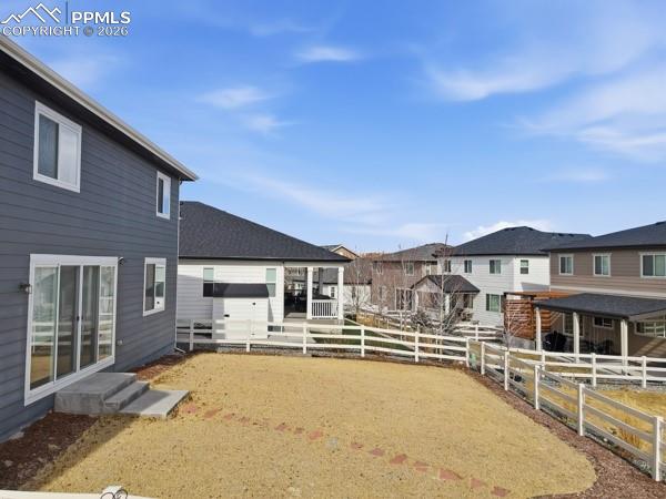 Image 35 of 36: Fenced backyard with a residential view