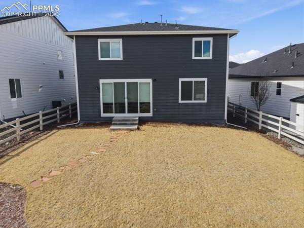 Image 36 of 36: Rear view of property featuring a fenced backyard