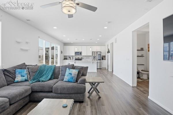 Image 5 of 36: Living room featuring ceiling fan, light wood finished floors, and recessed