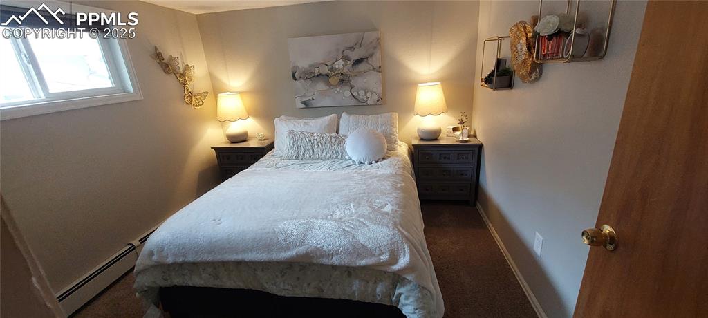 Image 10 of 46: Bedroom featuring baseboard heating and carpet floors