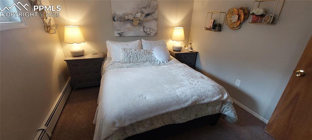 Image 11 of 46: Bedroom featuring carpet and a baseboard radiator