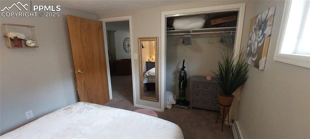 Image 12 of 46: Carpeted bedroom featuring a closet and baseboard heating