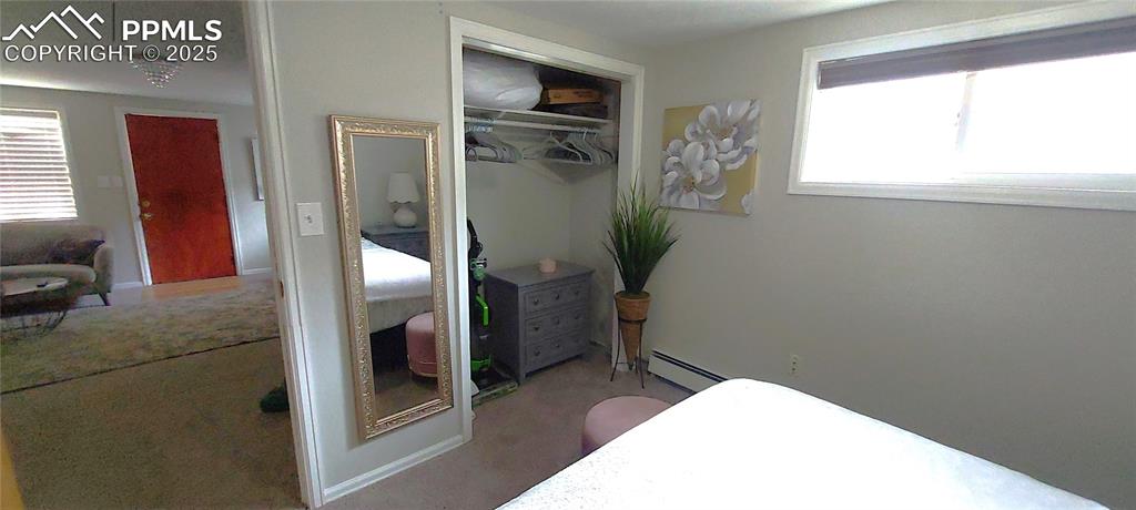 Image 13 of 46: Carpeted bedroom with a baseboard heating unit