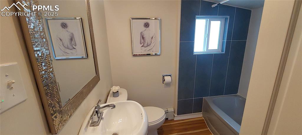 Image 21 of 46: Full bathroom featuring LVP floors, New tile and fixtures, tub / shower com