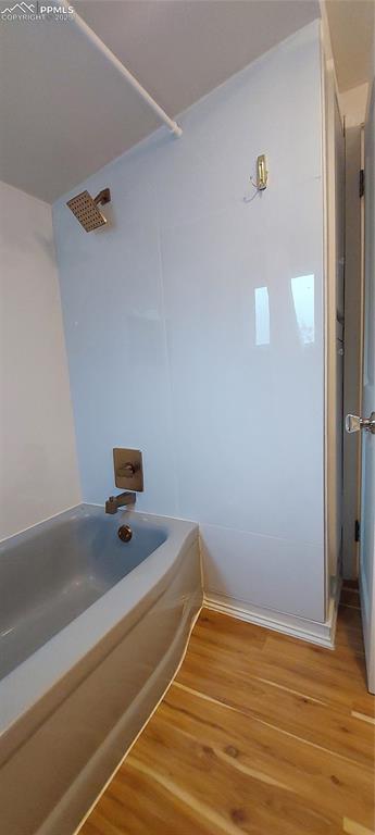 Image 24 of 46: Full bathroom featuring LVP floors, New tile and fixtures, tub / shower com