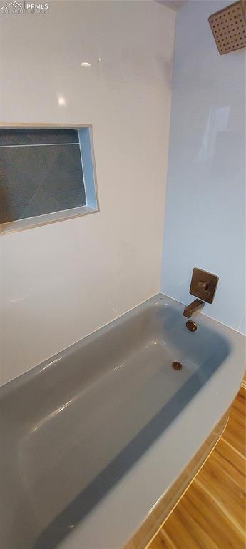 Image 25 of 46: Full bathroom featuring LVP floors, New tile and fixtures, tub / shower com